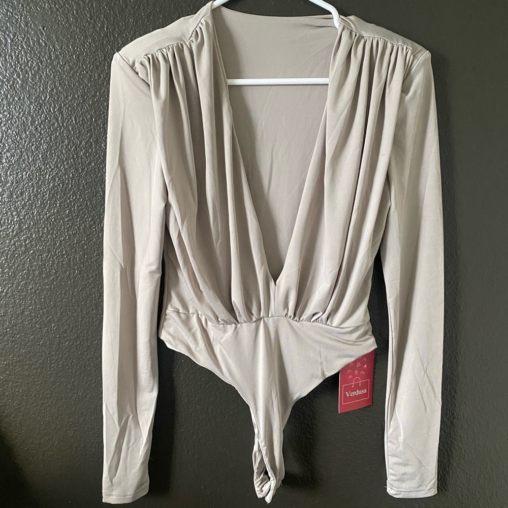 NEW WITH TAG. Deep V neck bodysuit size S.